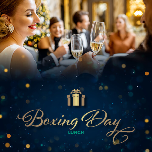 Festive family and friends in smart attire, toasting the Boxing Day lunch