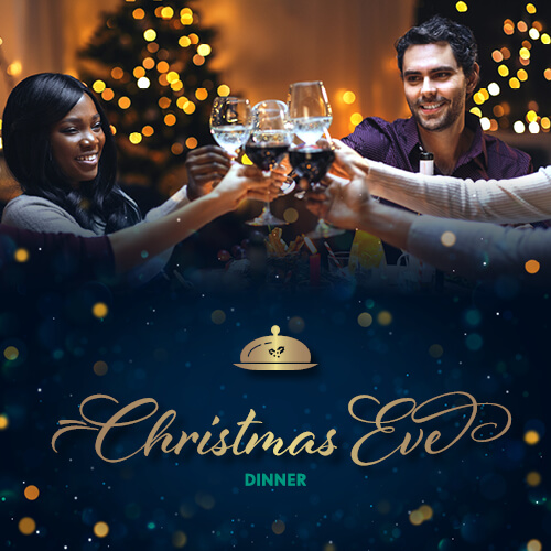 Friends sitting around festive table and toasting Christmas eve